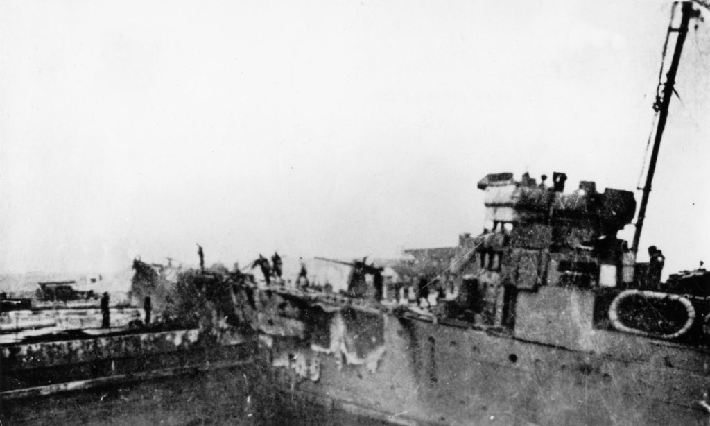 Le destroyer HMS Campbeltown encastré dans la porte-caisson de la forme-écluse Joubert quelques heures après l'opération Chariot.