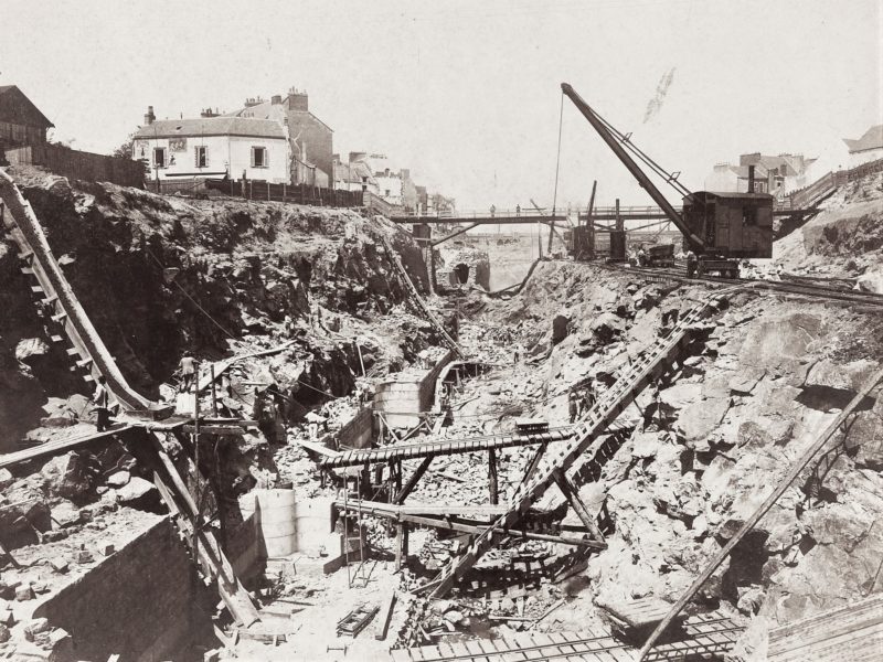Photographe : Théo Prat. Collection Saint-Nazaire Agglomération Tourisme - Écomusée. Photographie des travaux de l'entrée sud où l'on peut voir une immense tranchée séparant la ville en deux.
