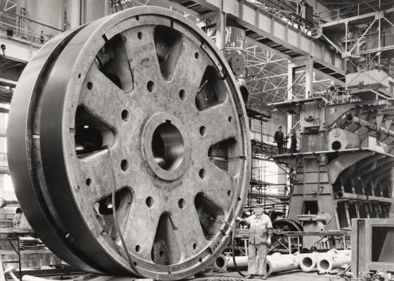 Un ouvrier devant une roue de réducteur d'un groupe turbo-réducteur principal de France (1962).